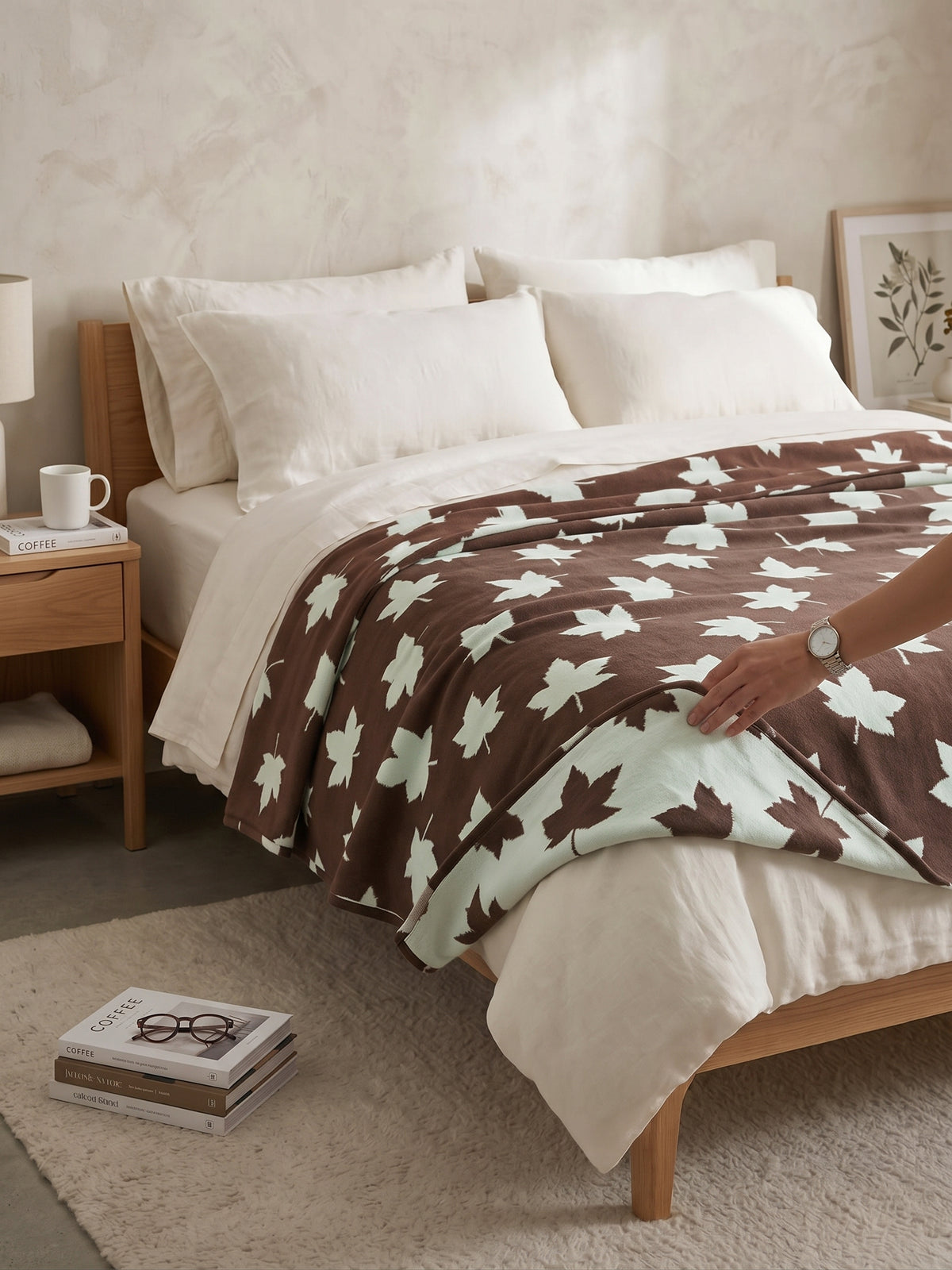 Manta NH en color Marrón, diseño Hojas, extendida sobre una cama